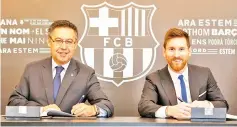  ?? — AFP photo ?? This handout photo taken on November 25,2017 in Barcelona and released by the Barcelona FC press office, shows Barcelona FC President Josep Maria Bartomeu (L)and Barcelona's Argentinia­n forward Lionel Messi signing a contract extension keeping Messi at...