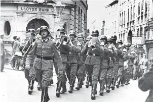  ?? ?? INVASION Nazi soldiers march through the centre of Guernsey in 1940