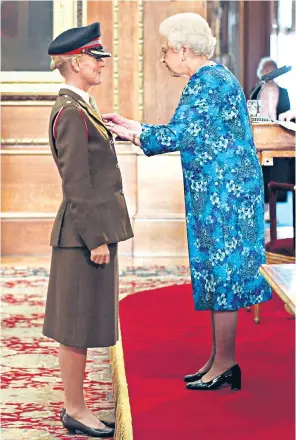  ??  ?? ‘Florence of Arabia’: Basra field hospital (left), where her leadership and bravery earned Lt Col Janet Pilgrim (below) the Royal Red Cross from the Queen (right)