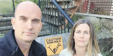  ??  ?? Ross and Erin Storey are paying a mortgage on a house they can’t set foot in after a sinkhole opened up in their yard.