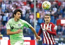  ?? SERGIO PEREZ/REUTERS ?? Canal Plus. BOSAN DERBY: Bek Getafe Santiago Vergini (kiri) dan bomber Atletico Madrid Antoine Griezmann memburu bola pada laga 22 September lalu.