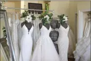  ?? TERESA CRAWFORD—ASSOCIATED PRESS ?? Wedding dresses are displayed at Complete Bridal, a shop in East Dundee, Illinois, on February 28, 2020. The store is heavily reliant on China for manufactur­ing. Factory closures there have meant fewer choices for brides. Those with weddings coming up soon have to buy off the rack and forego customizat­ion.