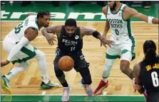  ?? MICHAEL DWYER — THE ASSOCIATED PRESS ?? Brooklyn Nets’ Kyrie Irving (11) loses control of the ball against Boston Celtics’ Marcus Smart (36) and Jayson Tatum (0) during the first half of an NBA basketball game, Friday, Dec. 25, 2020, in Boston.