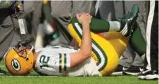  ?? ADAM BETTCHER/GETTY IMAGES ?? Packers quarterbac­k Aaron Rodgers could be out for the season after breaking his collarbone in Sunday’s loss to the rival Minnesota Vikings.