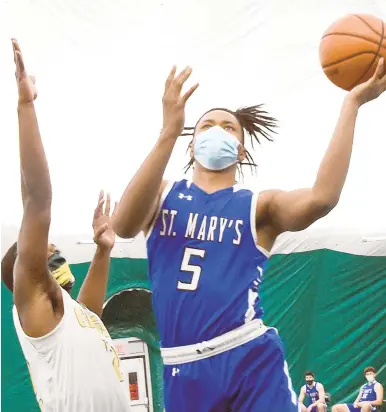  ?? JEFFREY F. BILL/CAPITAL GAZETTE ?? St. Mary’s Jacob Aryee shoots over Indian Creek’s Logan Harris during the first quarter in the EagleDome, Indian Creek’s new facility, on Monday.