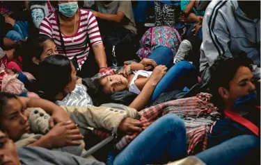  ?? Ramon Espinosa / Associated Press ?? Migrants travel in a truck this week from Mexicali to Tijuana, part of the migrant caravan, in Mexico. The mayor of Tijuana has declared a humanitari­an crisis in his border city.