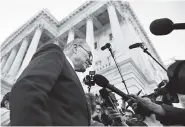  ?? THE ASSOCIATED PRESS ?? Senate Minority Leader Chuck Schumer, D-N.Y., center, speaks to members of the media Friday outside the Capitol after meeting with President Donald Trump.