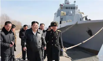  ?? — AFP photo ?? This undated photo shows Kim Jong Un (centre) inspecting the Nampho Dockyard in North Korea.