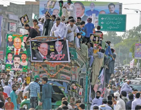  ??  ?? This file photo shows supporters of Nawaz Sharif at a rally in Gujrat city in Punjab province on August 11 as the former prime minister continued a slow, defiant procession down the ancient Grand Trunk Road inching closer to his eastern stronghold of...