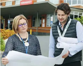  ??  ?? West Gippsland Healthcare Group’s general manager support services Tanya Heaney-Vogt and director of corporate services Justin Walsh look over plans for the new works at the Warragul hospital and temporary access arrangemen­ts ahead of this week’s start to the project.