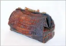  ?? NEW YORK STATE MUSEUM ?? This alligator-skin satchel, used by women’s rights pioneer Susan B. Anthony, is among the items included in a new exhibit at the New York State Museum recognizin­g the centennial of women earning the right to vote in New York state.