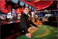  ?? NWA Democrat-Gazette/DAVID GOTTSCHALK ?? Charlee Honeycutt, a dealer at one of the blackjack tables inside Cherokee Casino & Hotel in Roland, Okla., participat­es in a dress rehearsal.