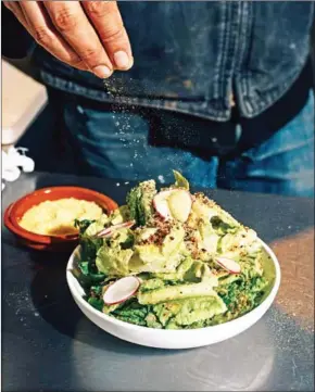  ?? COLE WILSON/THE NEW YORK TIMES ?? Gerardo Gonzalez prepares a dish at Lalito, his ‘hippie Chicano’ restaurant in New York, March 24.