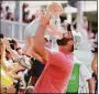  ?? Hector Vivas / Getty Images ?? Jon Rahm holds his son after making a par in the 18th hole to win the Mexico Open on Sunday.