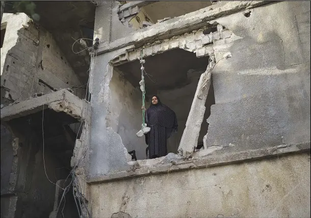  ??  ?? Jawaher Nassir looks out from a room of her home June 11.