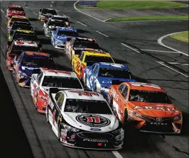  ?? SEAN GARDNER / GETTY IMAGES ?? Kevin Harvick, driver of the No. 44 Jimmy John’s Ford, and Daniel Suarez, in the No. 19 ARRIS Toyota, lead the field during the All-Star Race.