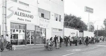  ?? WENDY FRY U-T ?? Long lines form outside nonprofit soup kitchen Padre Chava in Tijuana’s northern zone where people wait to get a daily breakfast served at 8 a.m.