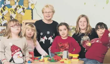  ??  ?? Maggie Scott with children from the Peterborou­gh Area Down’s Syndrome Group (PADSG).