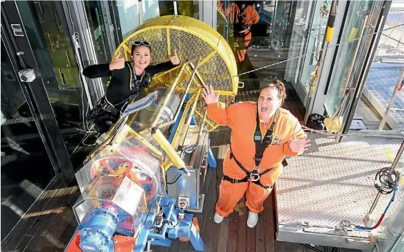  ??  ?? Paula Sadgrove, right, with a SkyJump crew member about to take the plunge off the Auckland Sky Tower.