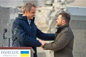  ?? UKRAINIAN PRESIDENTI­AL PRESS OFFICE VIA AP ?? Ukrainian President Volodymyr Zelenskyy, right, and Greece’s Prime Minister Kyriakos Mitsotakis shake hands Wednesday in Odesa, Ukraine.