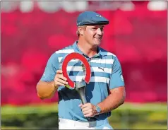  ?? CARLOS OSORIO/AP PHOTO ?? Bryson DeChambeau holds the Rocket Mortgage Classic trophy after winning the tournament on Sunday at Detroit Golf Club in Detroit.