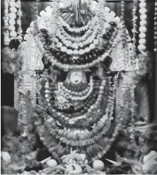  ??  ?? An idol of the Hindu mother goddess Devi Saraswati is wrapped in fruits and vegetables at Sri Siva Vishnu Temple. Photo courtesy of Ashwani Ramamurty