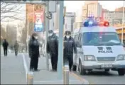  ?? AFP ?? Police keep watch on a road in Beijing on Tuesday.