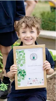  ??  ?? Jimmy Thorne proudly displays the certificat­e that Ellinbank Primary School won in November thanks to its outstandin­g garden project.
