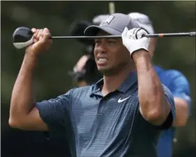  ?? JEFF ROBERSON — THE ASSOCIATED PRESS ?? Tiger Woods reacts to his second shot on the eighth hole during the first round of the PGA Championsh­ip at Bellerive Country Club, Thursday in St. Louis.