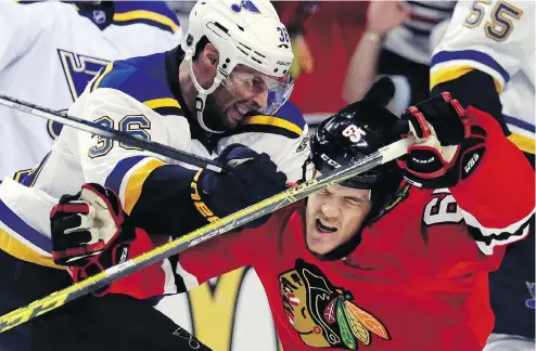  ?? NAM Y. HUH / THE ASSOCIATED PRESS FILES ?? Chicago winger Andrew Shaw is hit by St. Louis winger Troy Brouwer in the 2016 Stanley Cup playoffs. Despite calls from former stars Eric Lindros and Ken Dryden to ban bodychecki­ng, recent legal decisions would make that difficult, writes Scott Stinson.