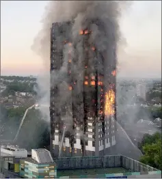  ??  ?? This file photo shows flames and smoke coming from the 27-storey block of flats after a fire broke out in west London. — AFP photo