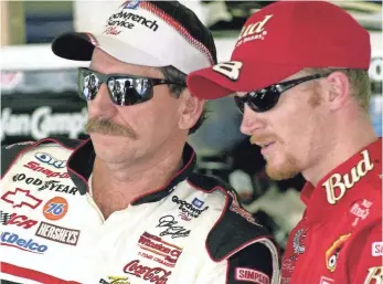  ?? PAUL KIZZLE AP ?? Dale Earnhardt and son Dale Jr. stand together at Daytona Internatio­nal Speedway in 2001.