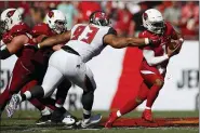  ?? JEFF HAYNES — THE ASSOCIATED PRESS FILE ?? In this Nov. 10, 2019, file photo, Tampa Bay Buccaneers nose tackle Ndamukong Suh (93) brings down Arizona Cardinals quarterbac­k Kyler Murray (1) during an NFL football game in Tampa, Fla. The Buccaneers announced Thursday that the team had re-signed defensive lineman Ndamukong Suh.