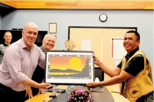  ?? PHOTO BY BARBARA GEERNAERT ?? Premier John Horgan presents Nak’azdli Whut’en Chief Alec McKinnon, right, with a painting Tuesday morning as Scott Fraser, centre, Minister for Indigenous Relations and Reconcilia­tion, looks on.