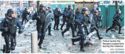  ?? JOEL GOODMAN ?? Police tackle the Rangers supporters during the violence