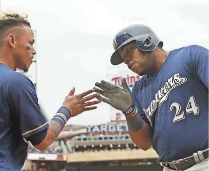  ?? ASSOCIATED PRESS ?? Jesus Aguilar (right) is congratula­ted by Orlando Arcia after he socks a solo home run in the fourth Saturday night.