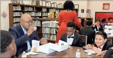  ?? Kenya Hunter ?? Rome school board member Alvin Jackson (from left) eats with Anna K. Davie students Lamar Harris and Isael Luis at the school’s Black History Month program.