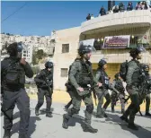  ?? MAHMOUD ILLEAN/AP ?? Israeli police march Friday in east Jerusalem. An 8-year-old child died Saturday from his injuries after a car rammed into a city bus stop a day earlier.