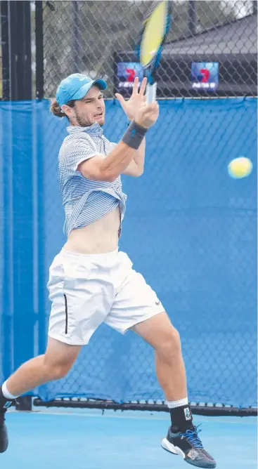  ?? Picture: ANNA ROGERS ?? GOING THE DISTANCE: Jacob Grills hammers a forehand during his almost eight-hour match against Brydan Klein in the final of the Cairns Tennis Internatio­nal yesterday.