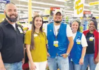  ?? (Photo courtesy of TCAC) ?? Kaleigh Dotson, second from left, Texarkana Child Advocacy Center’s developmen­t specialist, stands with employees of Walmart Neighborho­od Market on Richmond Road after receiving a $1,250 check for Court Appointed Special Advocates on Monday in Texarkana, Texas. The funds will be used to train advocates for children who have dealt with abuse.