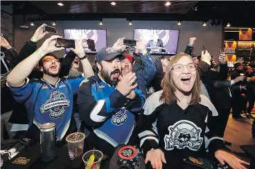  ?? — THE ASSOCIATED PRESS ?? Hockey fans Ryan Kelly, left, Otto Rogers and Rebecca Moloney whoop it up at a celebrator­y party on Tuesday after hearing that Seattle is getting an NHL team. The NHL’s 32nd franchise is slated to begin play in 2021.