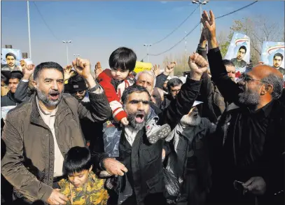  ?? Ebrahim Noroozi ?? The Associated Press Iranian worshipper­s chant slogans against anti-government protesters after the Friday prayer ceremony in Tehran, Iran.