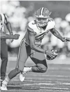  ?? BEN QUEEN/USA TODAY SPORTS ?? Maryland quarterbac­k Taulia Tagovailoa escapes the pocket and pressure from West Virginia’s Vandarius Cowan during Saturday’s game.