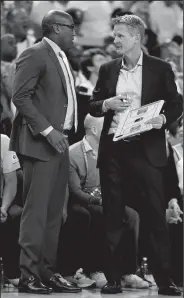  ?? NHAT V. MEYER/TRIBUNE NEWS SERVICE ?? Golden State Warriors coaches Steve Kerr, right, and Mike Brown talk during a timeout against the Cleveland Cavaliers in the second quarter of Game 5 of the 2017 NBA Finals.