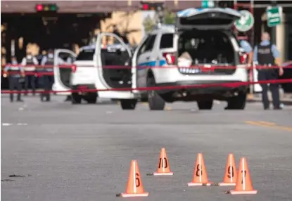  ??  ?? Chicago police investigat­e Monday on Lake Street near Michigan Avenue where officers exchanged gunfire with someone overnight.