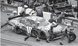  ?? Associated Press ?? ■ NASCAR driver Kyle Busch (18) pits Oct. 15 during an Xfinity series auto race at Kansas Speedway in Kansas City, Kan.