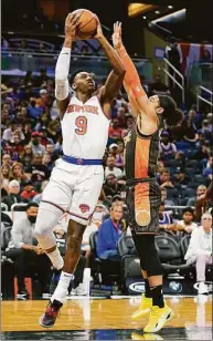  ?? John Raoux / Associated Press ?? The Knicks’ RJ Barrett (9) takes a shot over the Magic’s Devin Cannady on Sunday in Orlando, Fla.