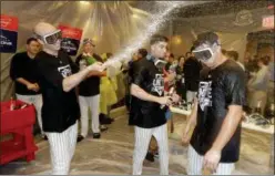  ?? FRANK FRANKLIN II — THE ASSOCIATED PRESS ?? Yankees players celebrate in the locker room after their 7-2 win over the Athletics in Wednesday night’s American League wild0card playoff game at Yankee Stadium in New York.