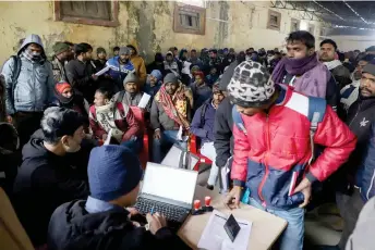  ?? — AFP photos ?? Indian workers submit registrati­on forms seeking employment in Israel during a recruitmen­t drive at the Industrial Training Institute (ITI) in Lucknow, capital of India’s Uttar Pradesh state.