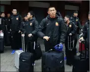  ?? MANU FERNANDEZ — THE ASSOCIATED PRESS ?? Players of the Chinese Super League team Wuhan Zall arrive at the Atocha train station in Madrid on Feb. 29.